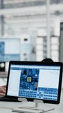 Vertical aspect: Female technician optimizes microchip production on computer monitor in factory office, combining digital analysis, tablet interface and engineering workflow. - Powered by Shutterstock - Get 15% off with code: PIKWIZARD15