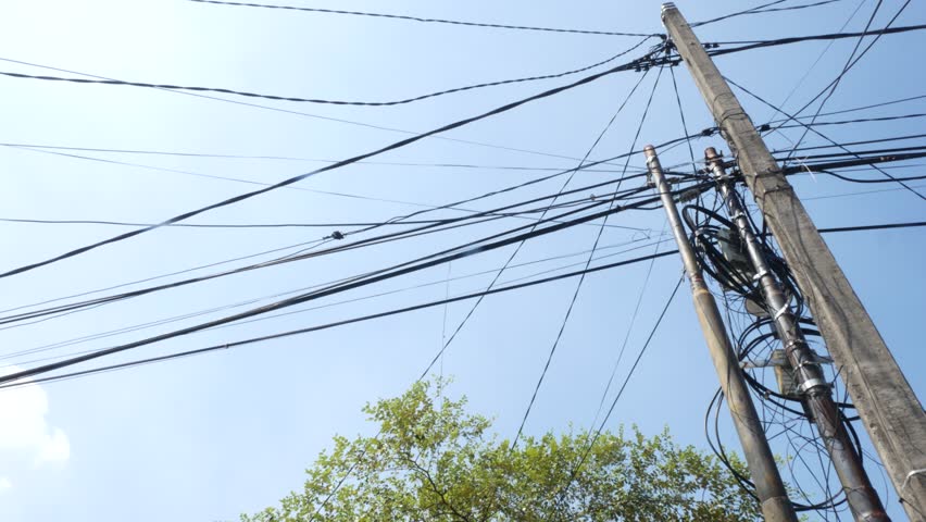 Utility Pole and Overhead Power Lines With Tree Against Clear Blue Sky, Urban Infrastructure