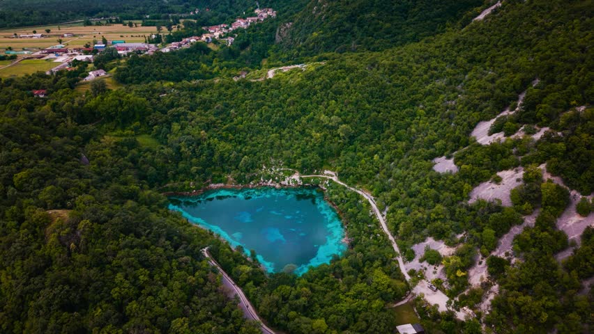 Lago Cornino mountain lake. Fresh clear blue spring with turquoise water borders, Italy. Scenic aerial