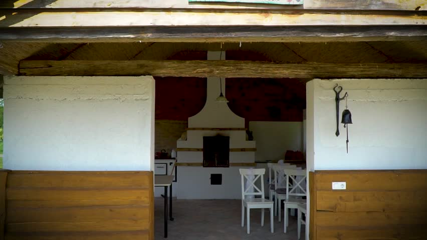 Zooming in on the open kitchen of an open-air museum, featuring a built-in oven at the far end.