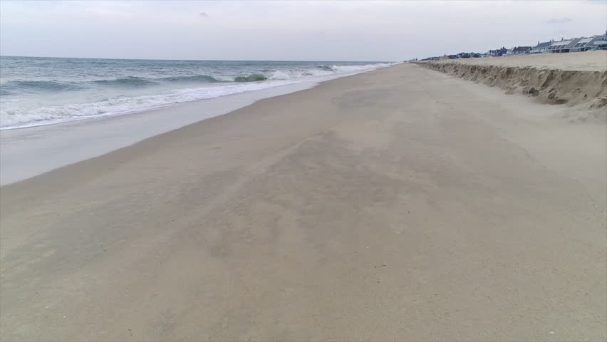 Walking south on the Atlantic coast of Delaware. Tracking shot.