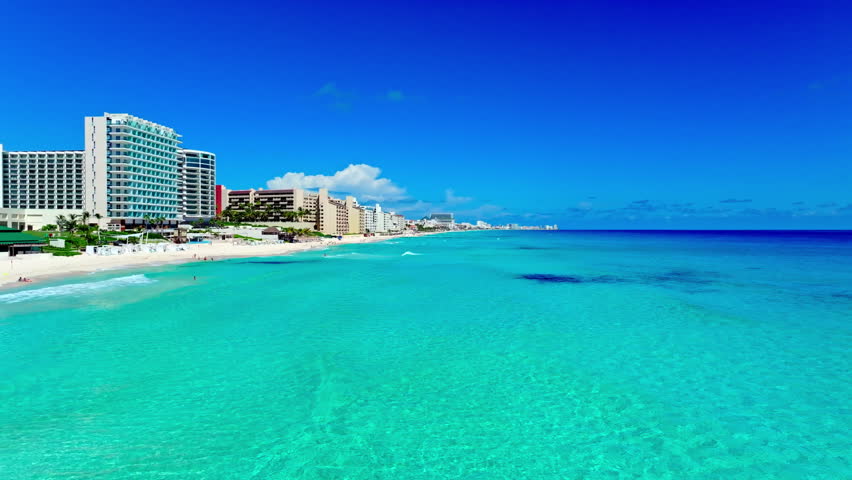 Aerial view of the Cancun Hotel Zone beach and resorts, Quintana Roo, Mexico, turquoise Caribbean water meeting the white-sand shore.