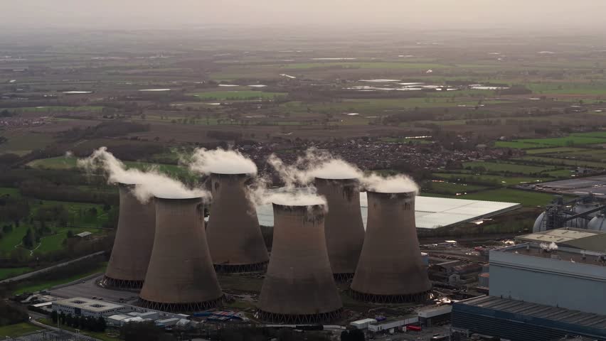 Drax renewable electricity generation plant with cooling towers and water vapour plumes, aerial view.