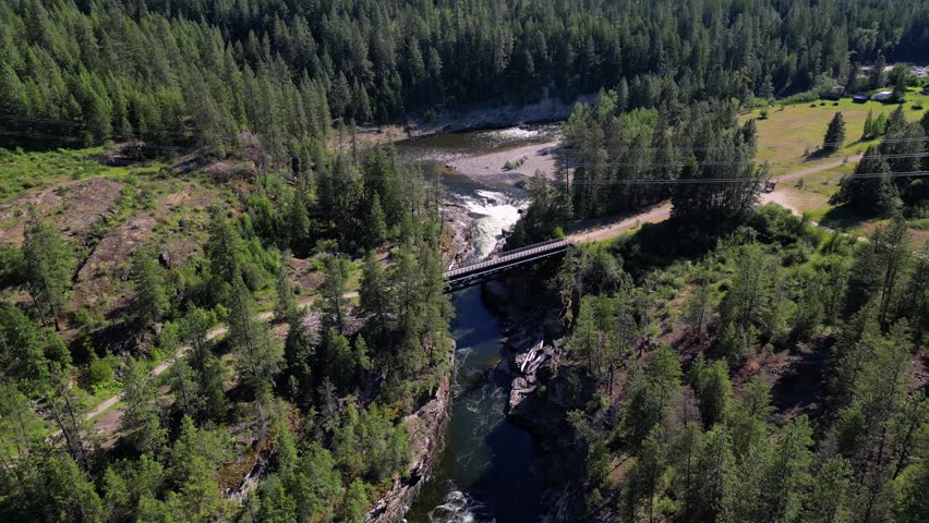 Aerial drone footage captures the historic Cascade Trestle spanning the Kettle River along the Columbia and Western Rail Trail in British Columbia.