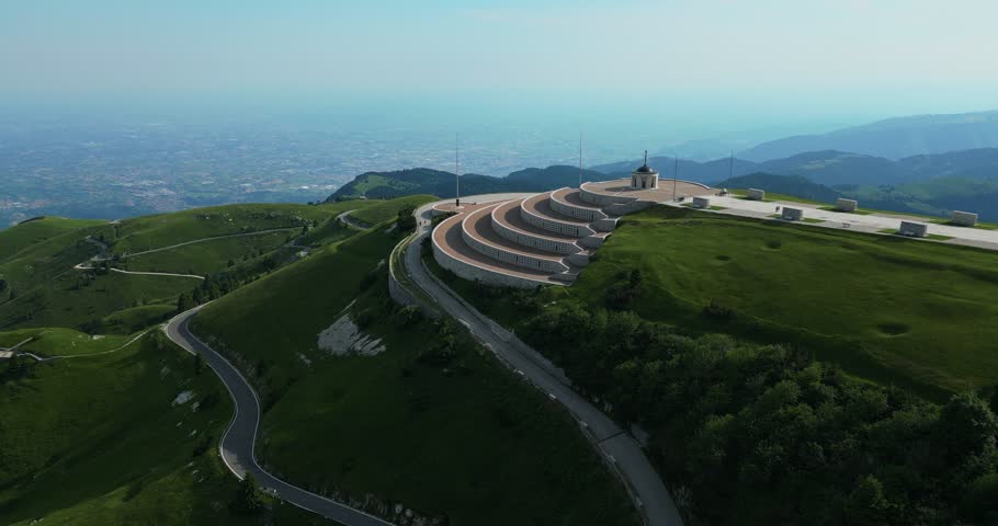 Hillside Road With Circular Stone Terraces Of Monte Grappa Military Memorial In Italy. Aerial Ascending Shot