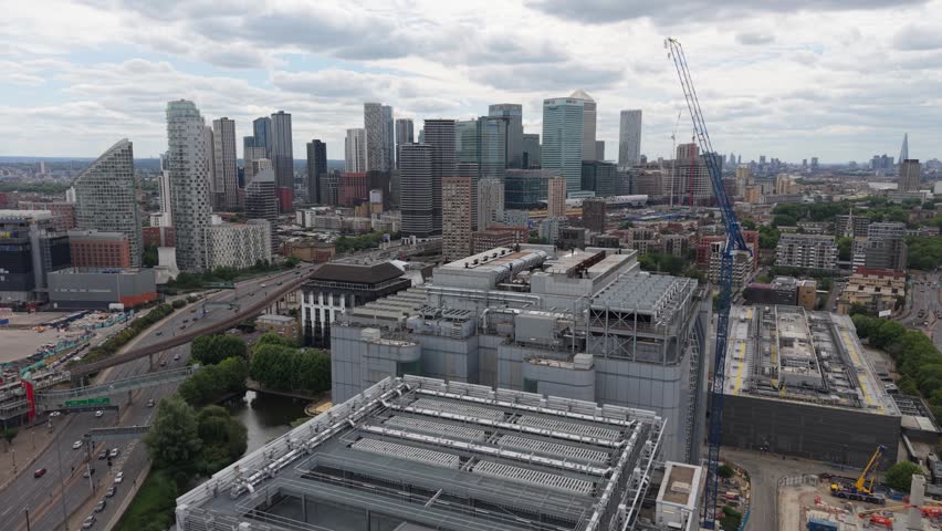 An aerial perspective shows the modern Canary Wharf Data Centre buildings under a cloudy daytime sky.