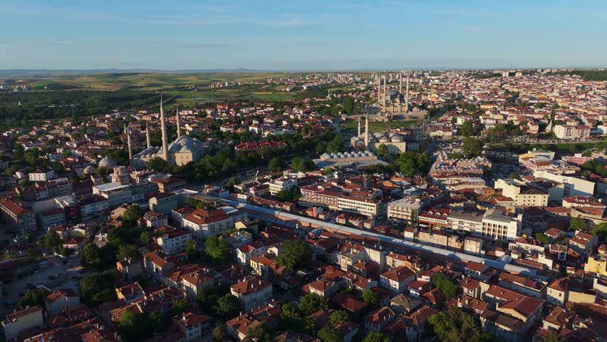 aerial drone tracking shot over the historic city of Edirne, Turkey. Cinematic viewpoint showcasing dense urban neighborhoods and cultural architectural heritage at daylight