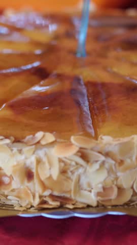 Professional pastry chef caramelizing a custard tart with blow torch. Slow motion close up showing the sugar burning and turning brown