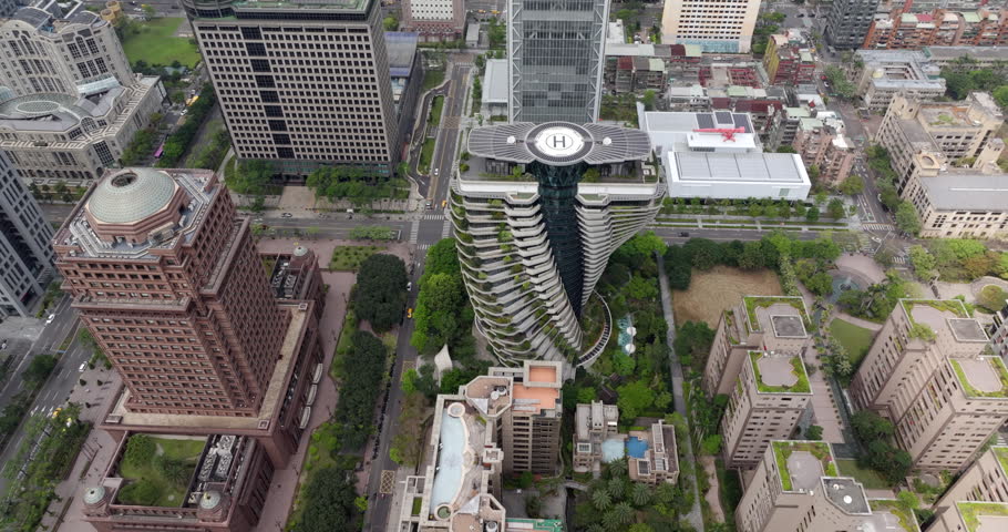 Aerial view of Taipei, the vibrant capital city of Taiwan, showing streets and modern skyscrapers in the Xinyi District during daytime.