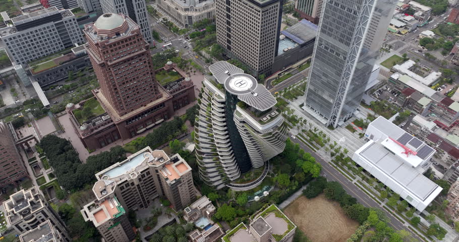 Aerial view of Taipei, the vibrant capital city of Taiwan, showing streets and modern skyscrapers in the Xinyi District during daytime. 