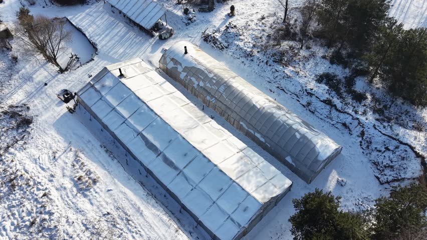 Aerial footage of a farm during snowy weather