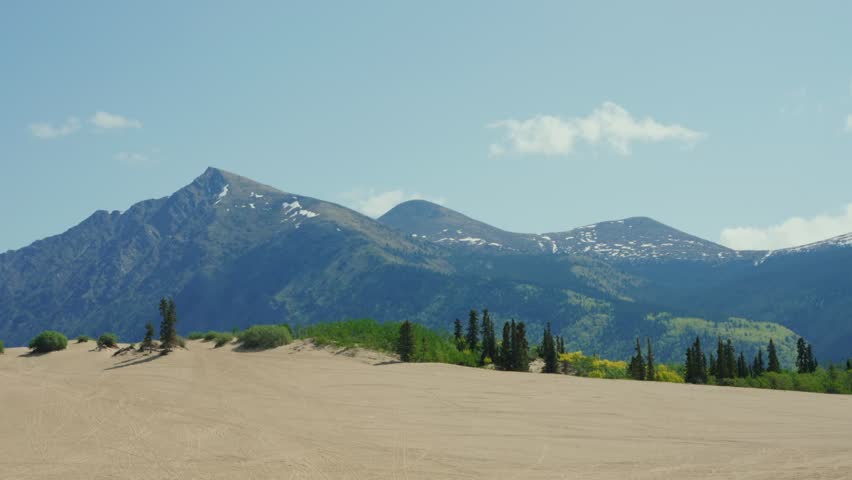 Carcross Desert sand dunes with mountains and trees in Yukon, Canada