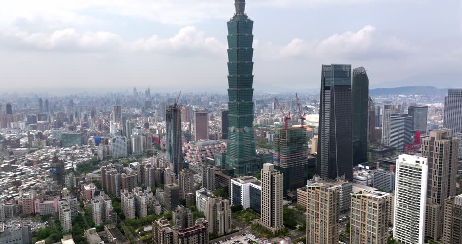 Aerial view of Taipei, the vibrant capital city of Taiwan, with the iconic Taipei 101 tower and other skyscrapers in the Xinyi Commercial District during daytime.