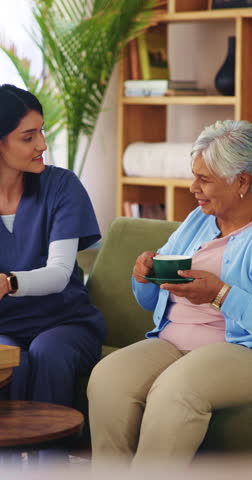Caregiver, tea and cookie for senior woman on house sofa for elderly care, homecare or assisted living. Happy, warm beverage of biscuit for old person with carer in retirement home for wellness