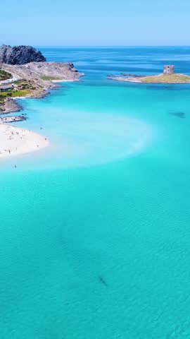 Vertical aerial view of La Pelosa beach in Sardinia, Italy, showing turquoise water, white sand and the iconic Mediterranean coastline from above.