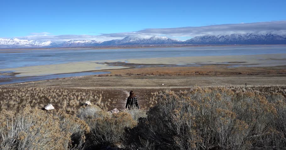 Woman looking at scenic view of Great Salt Lake and mountains, Utah