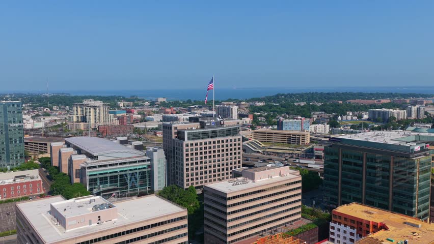 Stamford, CT skyline with big US Flag. Long Island Sound and I-95 highway in the background, 4K aerial.