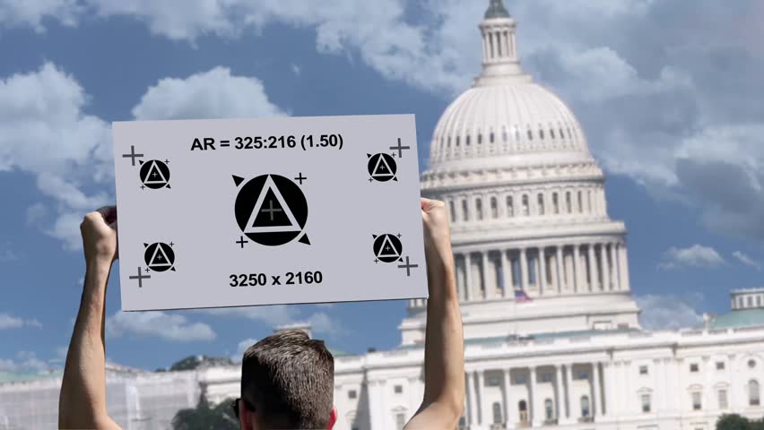 Rear view of a protester holding a motion tracking sign in front of the United States Capitol, allowing replacement with custom messages during post-production. 15231  