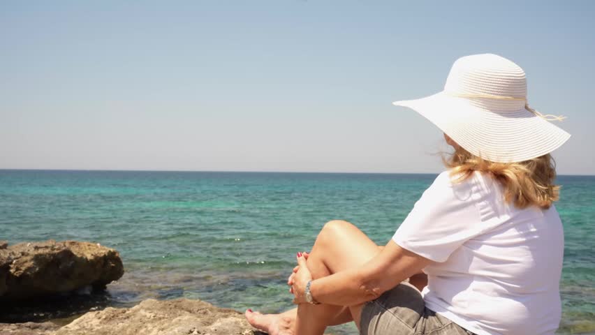 Mature Woman Resting Peacefully by the Ocean