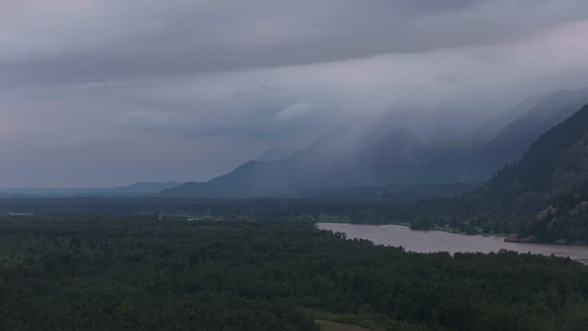 Misty Mountain Landscape with Lush Forest and River in British Columbia, Canada