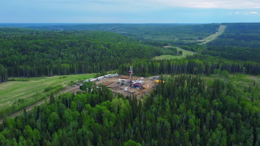 Oil Rig Surrounded by Vast Forest in Alberta, Canada