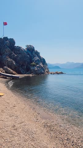 Summer coastal landscape with clear sea and mountain scenery in Marmaris, Turkey. Handheld, Vertical video