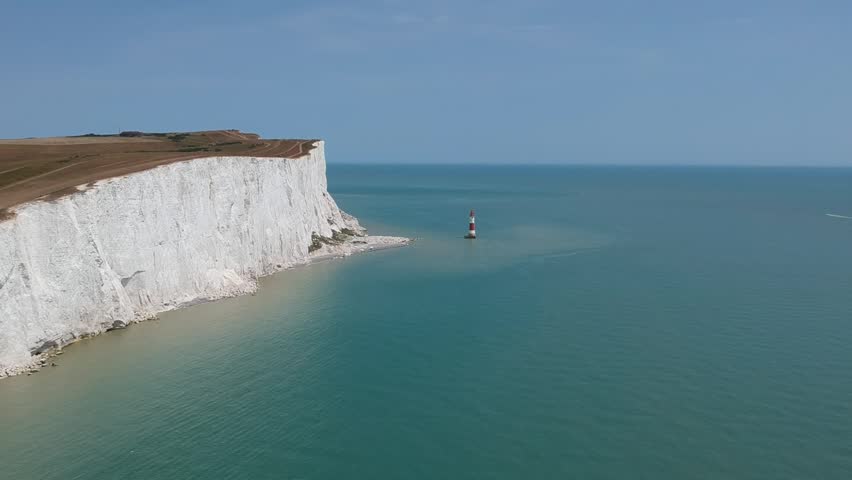 English Channel drone view of Seven Sisters cliffs UK with blue sea and chalk coastline