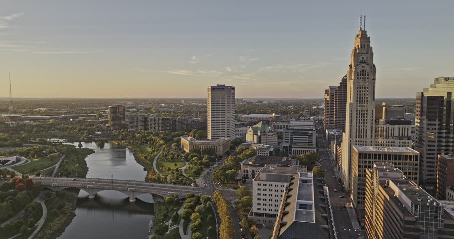 Columbus Ohio Aerial v66 drone flyover Scioto river capturing riverfront greenway, Discovery bridge, sunset cityscape across Arena district and downtown - Shot with 8k camera