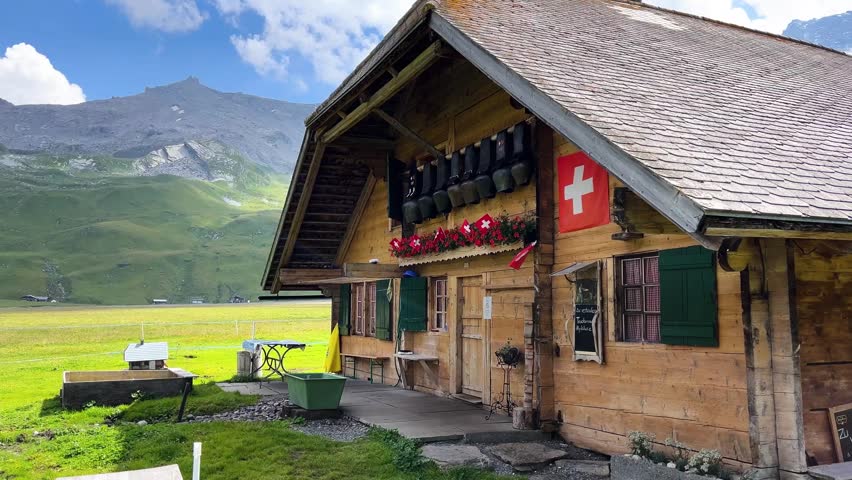 Swiss Mountain Cabin with National Flag and Alpine Scenery Ground View