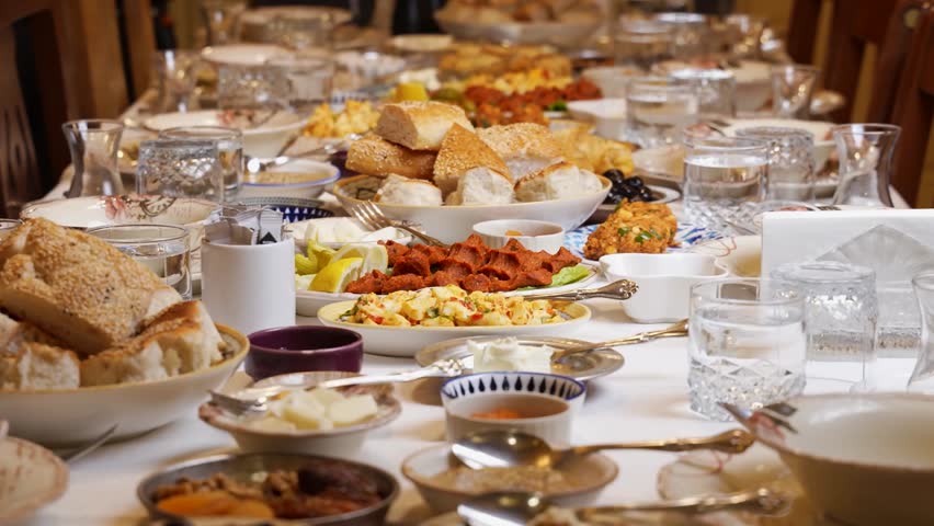 Traditional Table with Bread, Meat and Rustic Dishes Close-Up