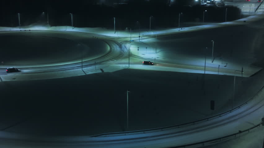 Bright streaks across wet road surfaces, Speeding vehicles create dynamic light patterns at night