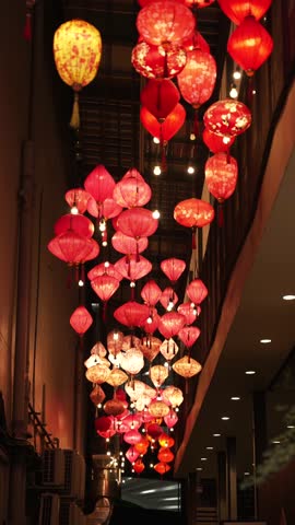 Vertical shot of Red and Gold Chinese Lanterns Hanging in Chinatown Alley at Night