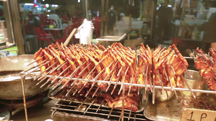 Close up of cooked BBQ chicken wings Skewers on Display Rack at Chinese Night Market Street Food Stall