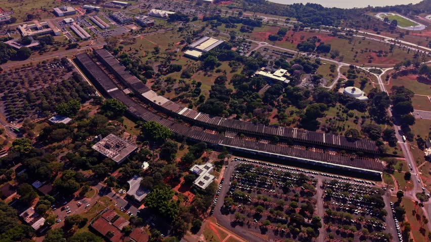 High altitude drone shot capturing the extensive curved structure of the Instituto Central de Ciências (Minhocão) at the University of Brasília