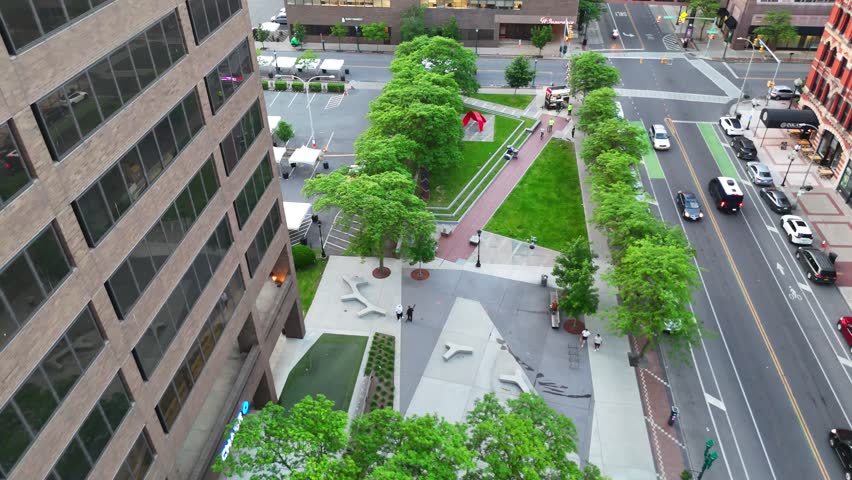 Several skateboarders utilize the urban landscape as they skate up and down a walkway located downtown.