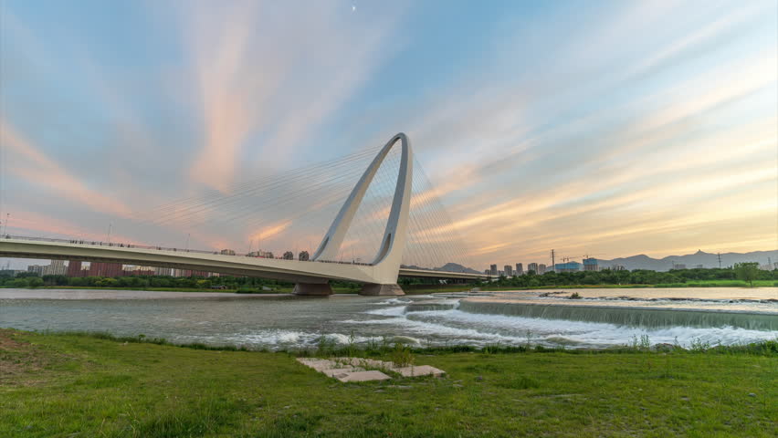 Sunset scenery over the Yongding River at the new Shougang Bridge in Beijing, China.