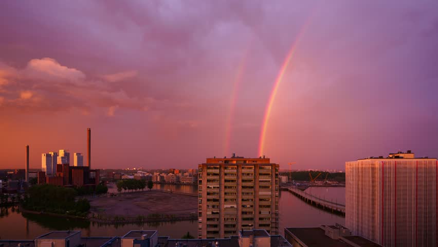 Timelapse of a rainbow over buildings in Merihaka district in Helsinki, dusk