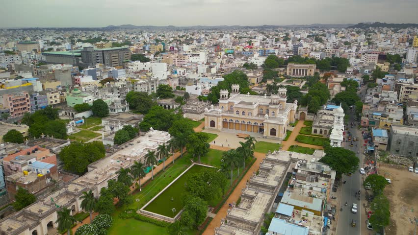 High angle view of the Charminar monument and a crowded street market in Hyderabad, India 