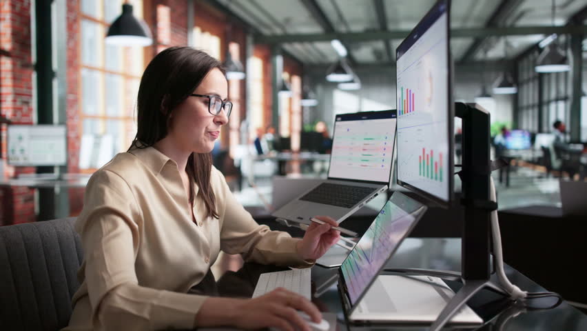 Young Woman Using Laptop And Tablet Tracking OKR Goals At Work, Business Analyst.