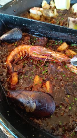 Close-up of Spanish black seafood paella
