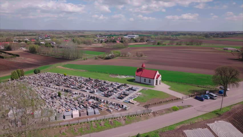 Wide drone view of peaceful cemetery in Tuczempy, Poland