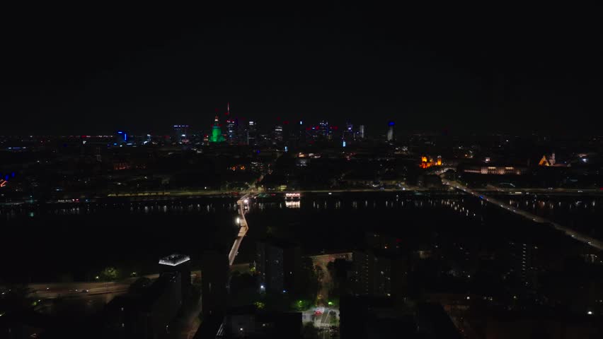 Warsaw, Poland - April 24, 2025: Night overall view with Vistula River centered, slight drone rotation