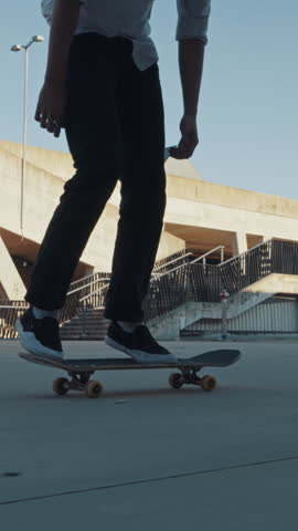 An adolescent skateboarder performs a flair trick at a concrete skatepark showing the carefree spirit of youth culture and the dynamic urban environment.