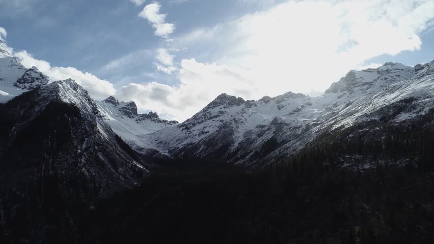 Aerial footage landscape of foggy snow capped mountains in sichuan, China