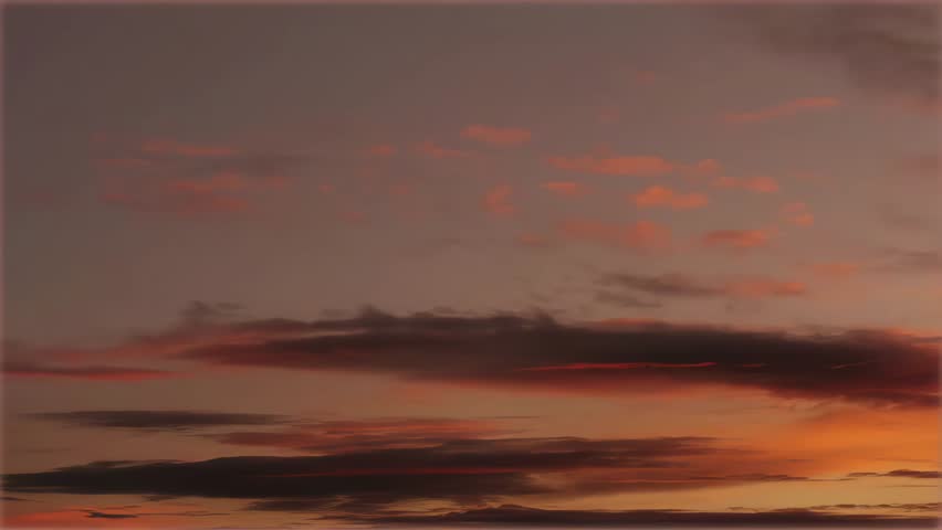 Orange Sunset Sky with Dramatic Clouds Moving in the Evening Atmosphere