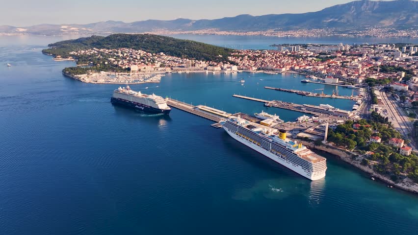 Large cruise ship maneuvering away from the pier in the harbor of split, croatia. Stunning aerial perspective of the historic city