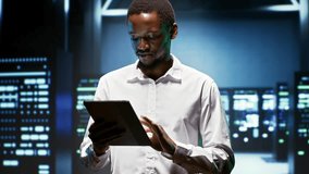 African American engineer supports AI computing in a data center, connecting artificial intelligence, machine learning workloads and large scale data processing during server hub. - Powered by Shutterstock - Get 15% off with code: PIKWIZARD15