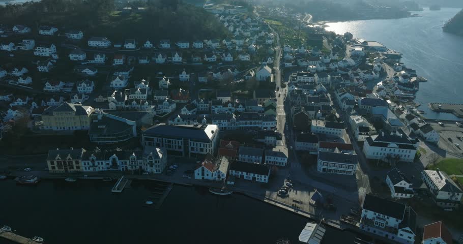 Aerial view of coastal town Farsund Norway with waterfront homes in slow motion