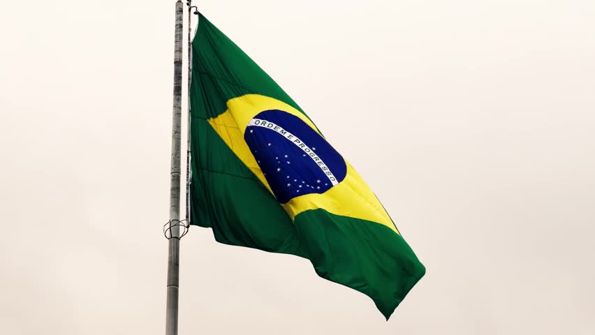 Brazilian Flag waving in the sky. Brazil.