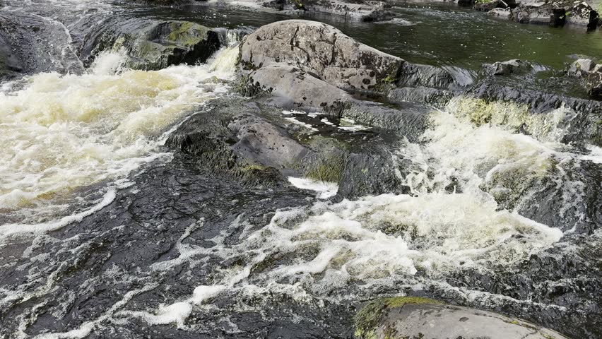 Scenic Northern Waterfall Flowing Through Rocky Forest Landscape in Karelia